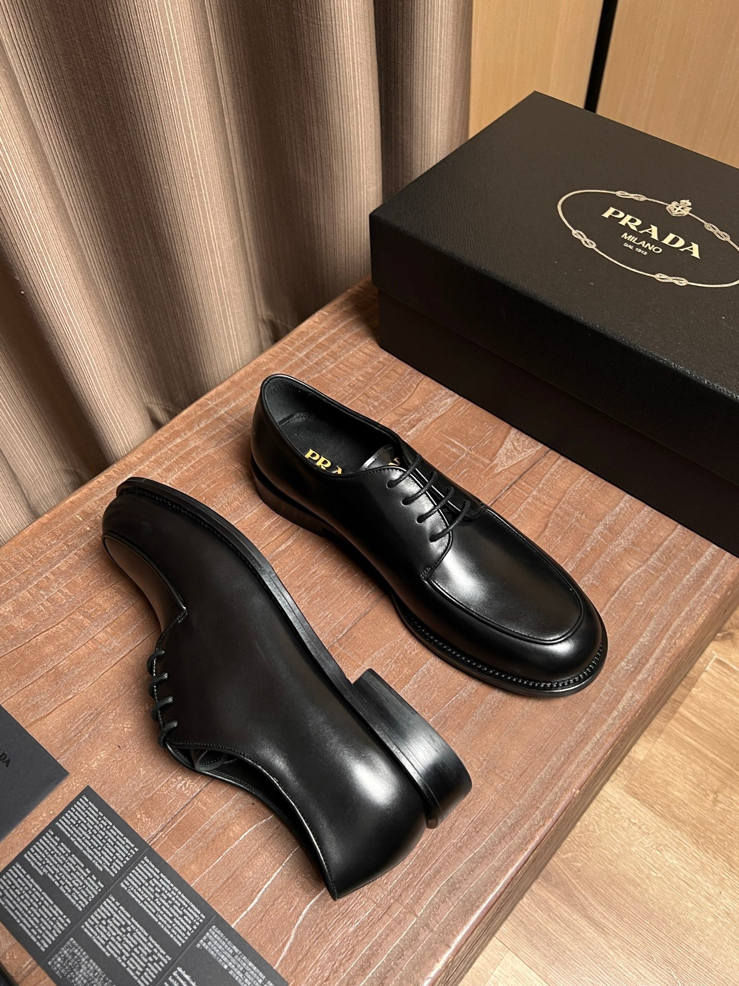 Black leather lace-up shoes with thick welt and rounded toe