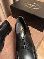 Black leather lace-up shoes showing tongue branding and lace-up front