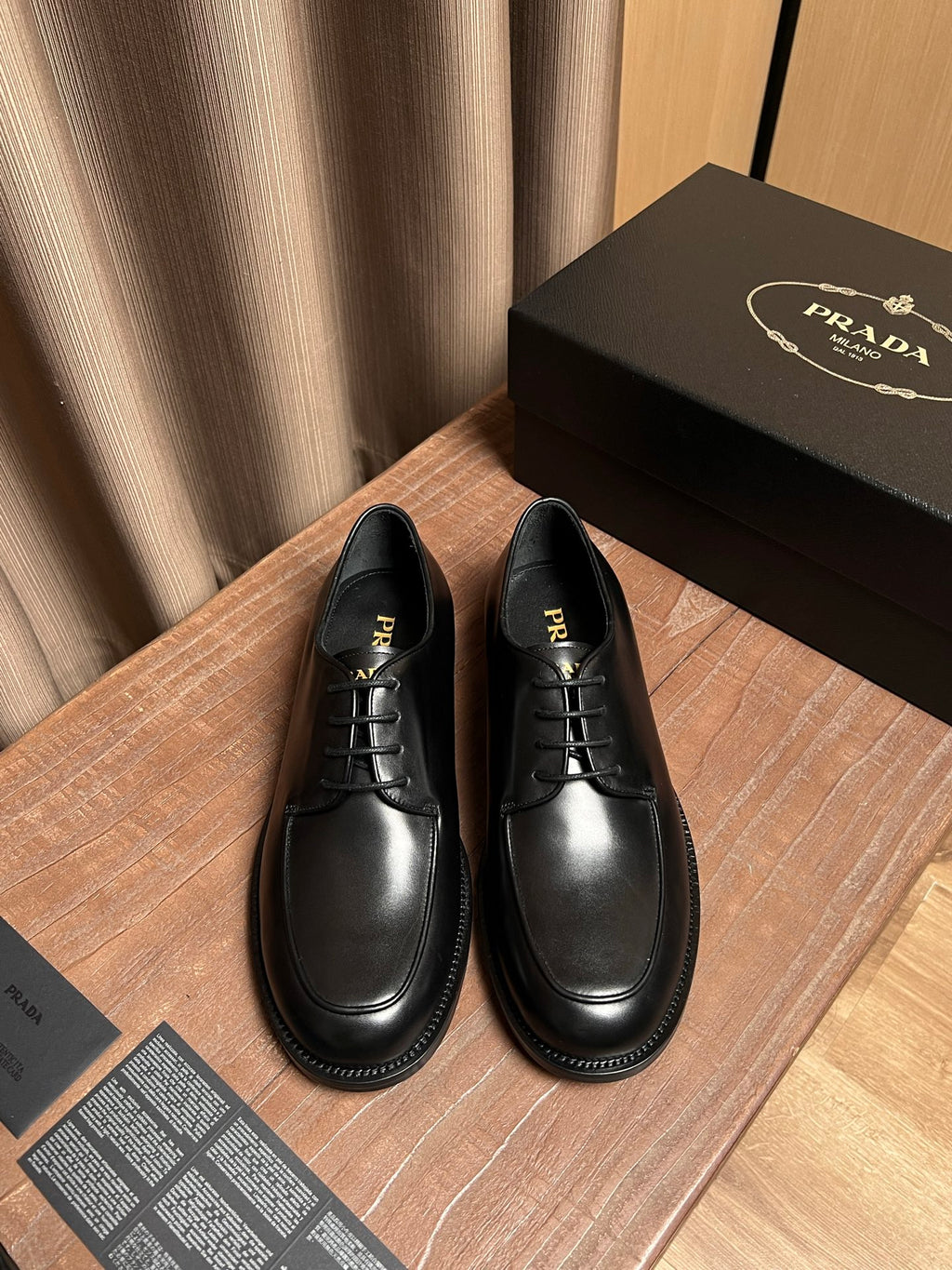 Black leather lace-up shoes with round toe and stitched sole edge