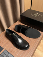 Black leather lace-up shoes with matching outsole and rounded toe