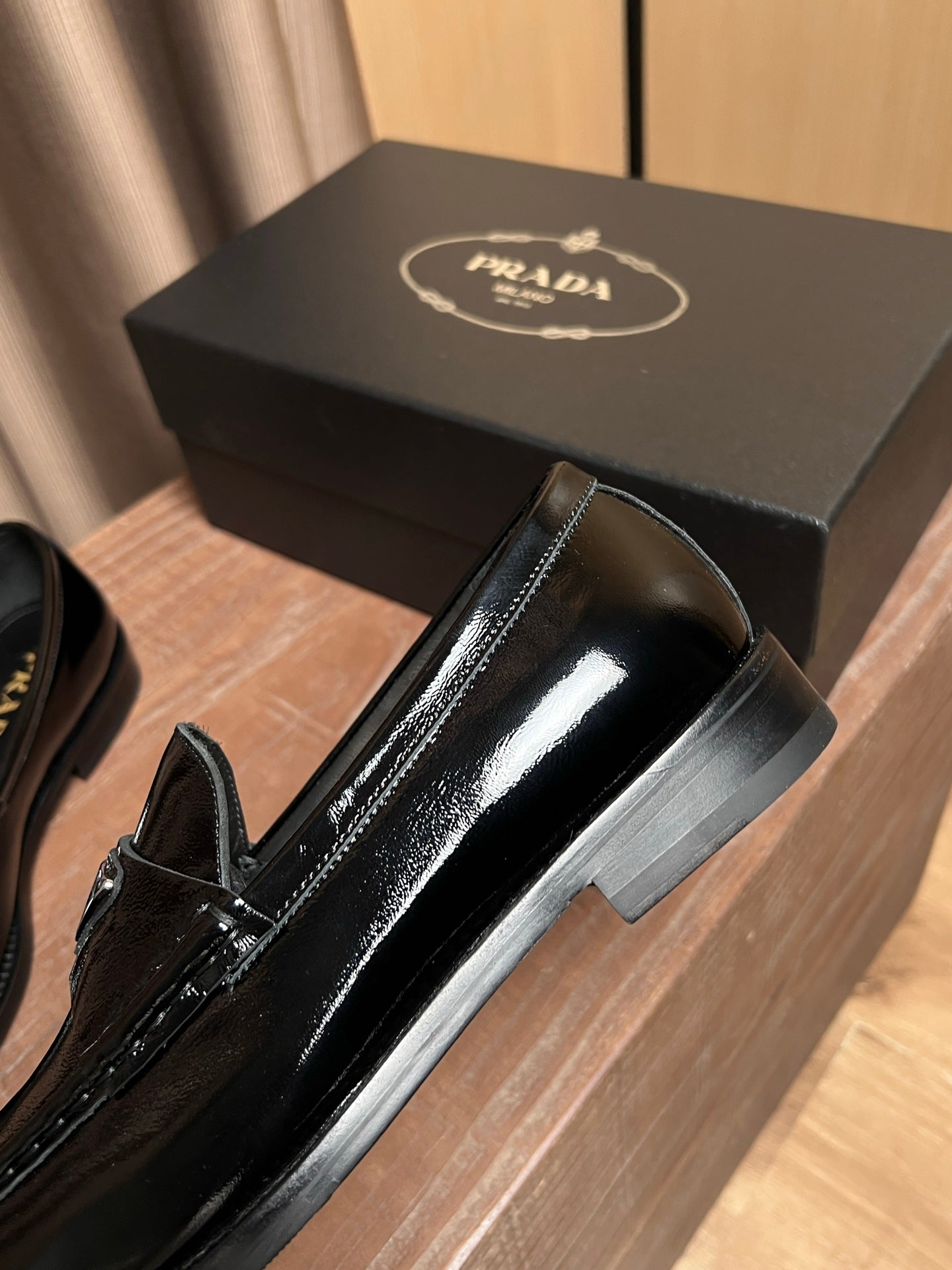 Black patent leather loafer side view with slip-on design and block heel