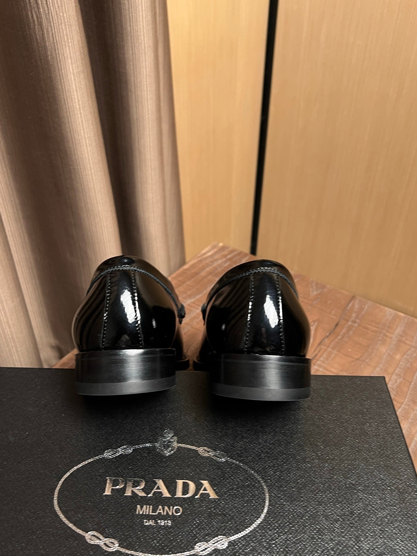Black patent leather loafers, back view with low stacked heels