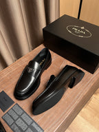Prada unisex black leather loafers with low heel and stitched welt detail
