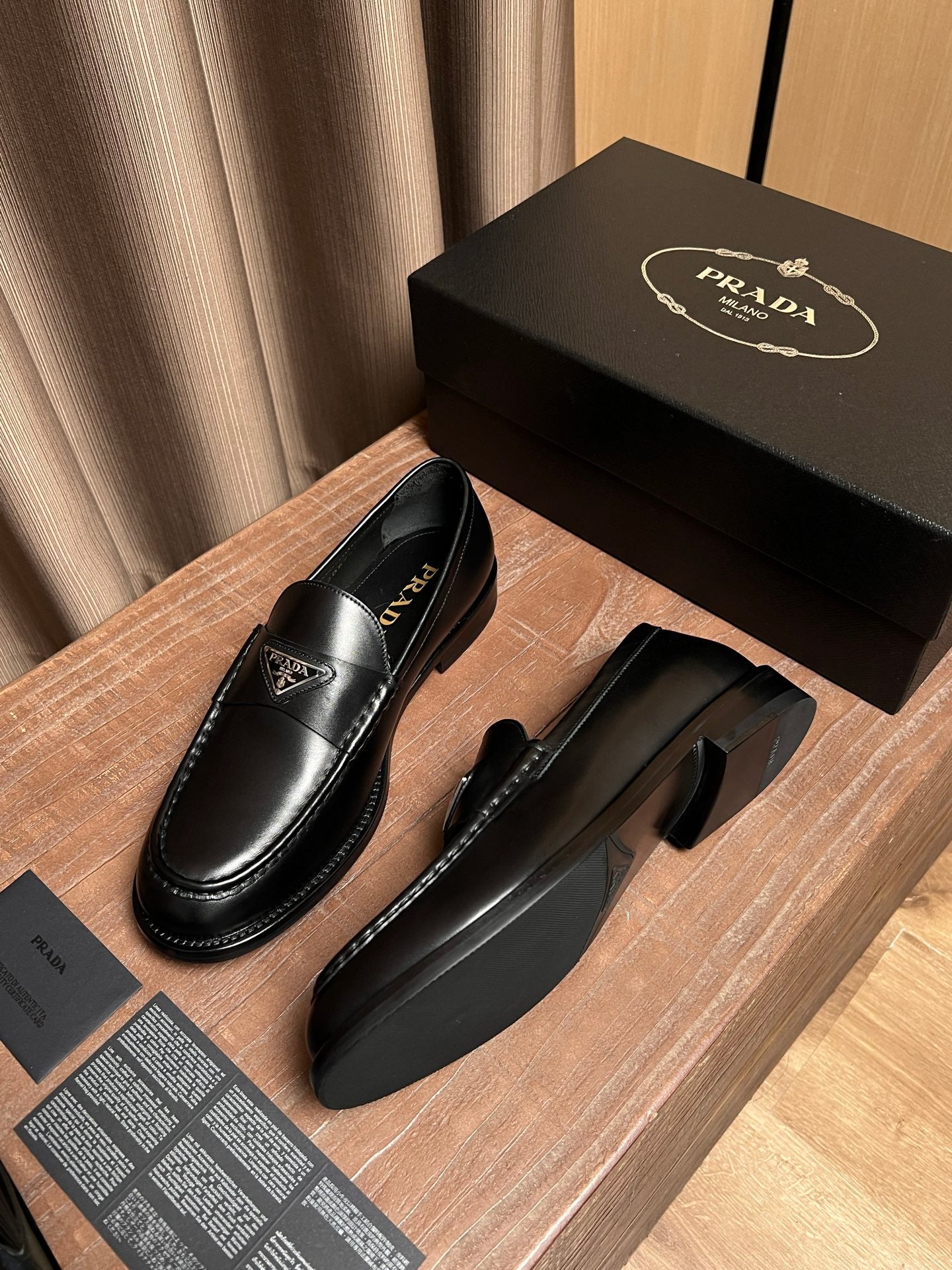 Prada unisex black leather loafers with low heel and stitched welt detail