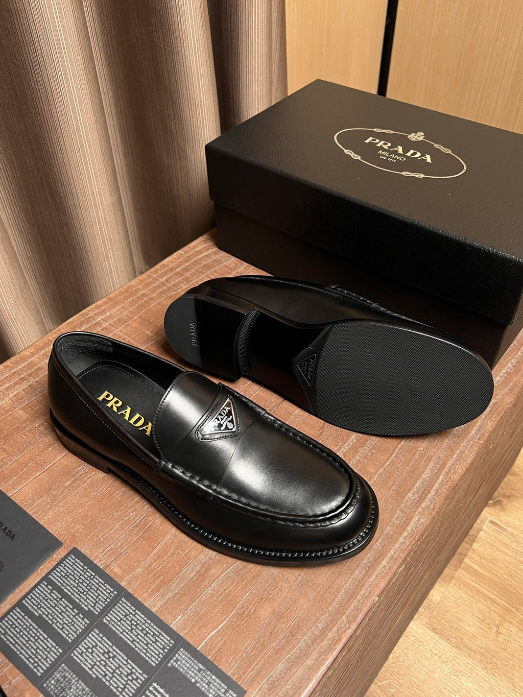 Prada unisex black leather loafers with PRADA branding on the vamp and lining