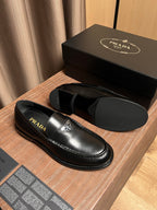 Prada unisex black leather loafers with PRADA branding on the vamp and lining