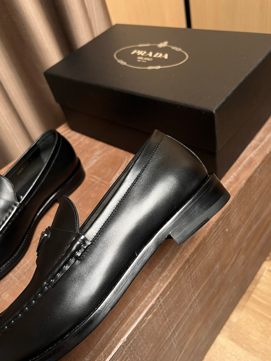 Prada unisex black leather loafer with side profile and low block heel