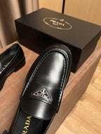 Prada unisex black leather loafer with logo plaque on vamp and stitched trim