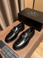 Prada unisex black leather loafers, rounded toe, low profile slip-on design