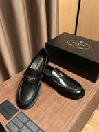 Prada unisex black leather loafers with logo patch and side seam stitching