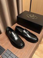 Prada unisex black leather slip-on loafers with logo detail and contrast stitching