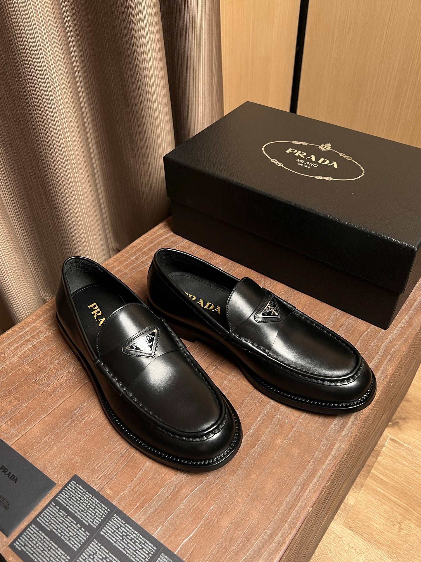 Prada unisex black leather slip-on loafers with logo detail and contrast stitching