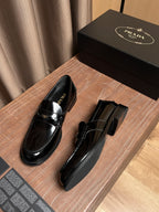 Black patent leather loafer with low stacked heel and side buckle strap
