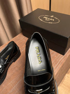 Black loafer with Prada-logo insole and glossy patent leather toe, close-up