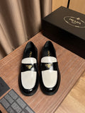 Prada unisex loafers in black with white panels and gold logo plaque