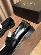 Prada black loafers, glossy leather with stitched apron and side logo