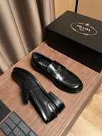 Black leather Prada loafers, side view with stitched detailing and chunky sole