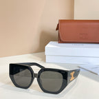 Black sunglasses with gradient amber lenses and gold logo on the temple