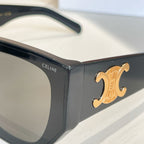 Black sunglasses close-up with gold emblem and CELINE text on the frame