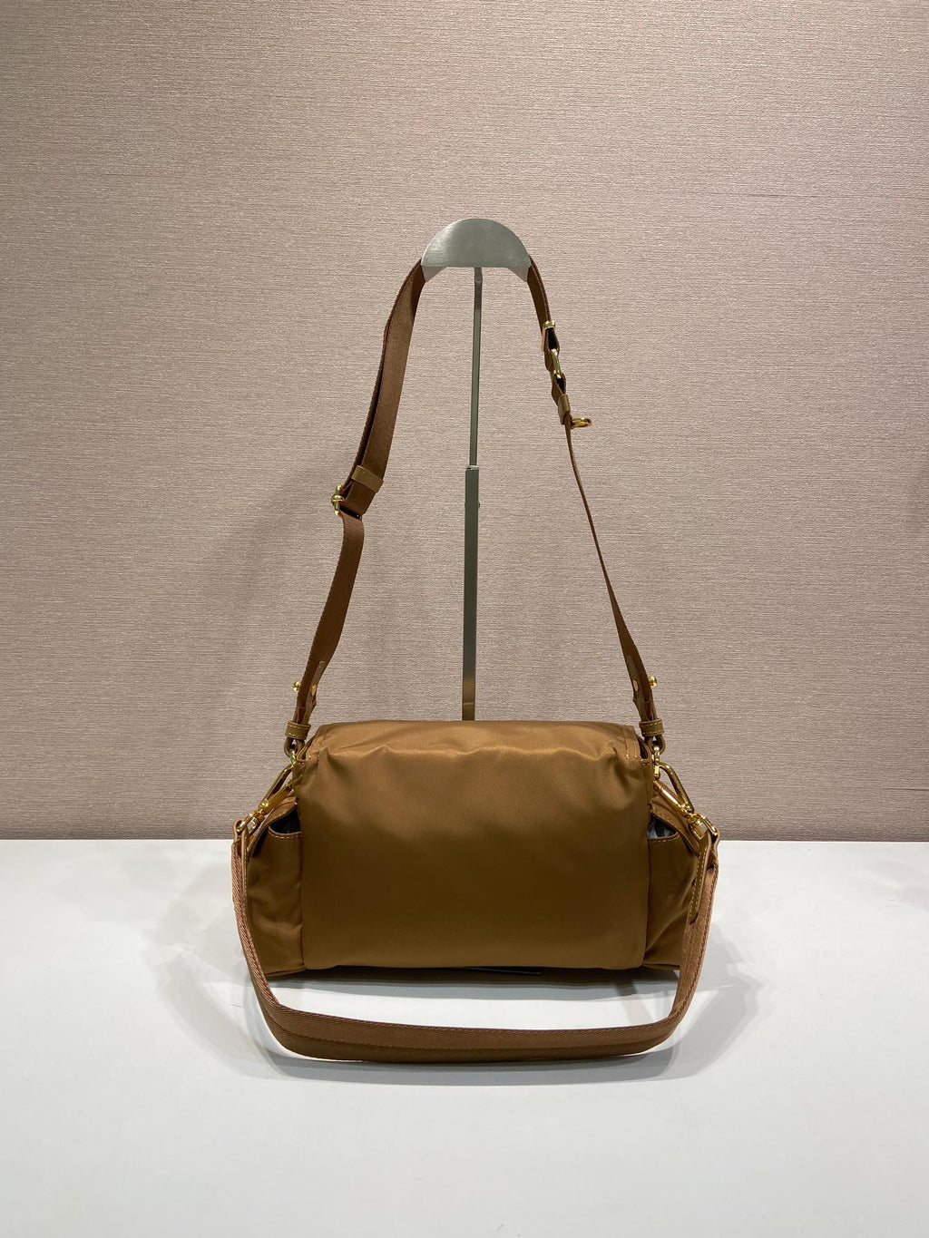 Prada shoulder bag in tan with long strap, flap front and gold hardware