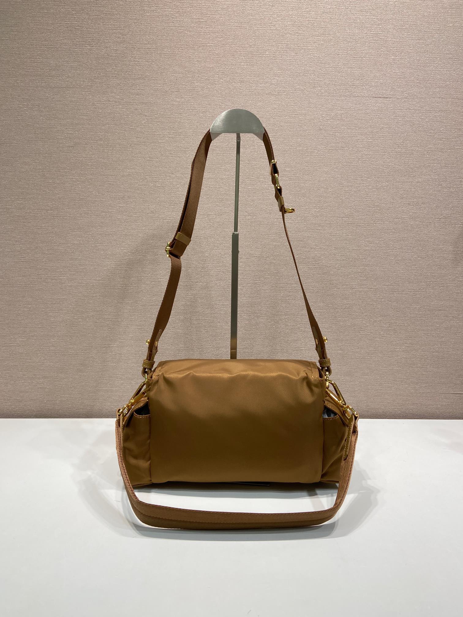 Prada shoulder bag in tan with long strap, flap front and gold hardware