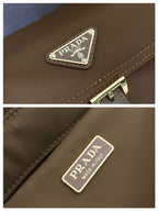 Prada bag logo plaque and Made in Italy tag on brown leather trim