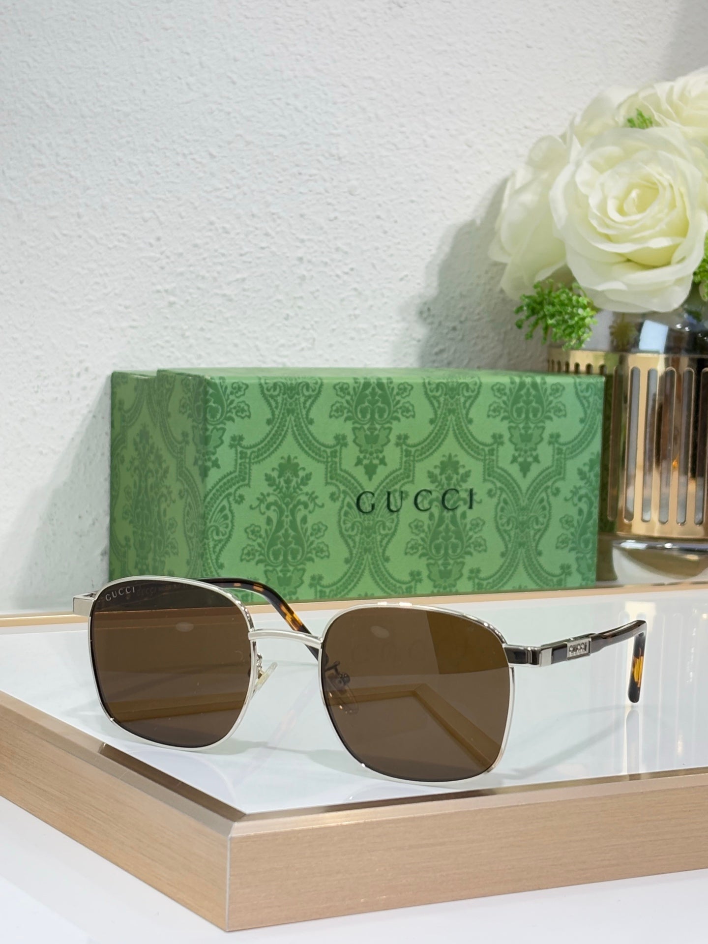 Gucci sunglasses with dark lenses and gold metal frame
