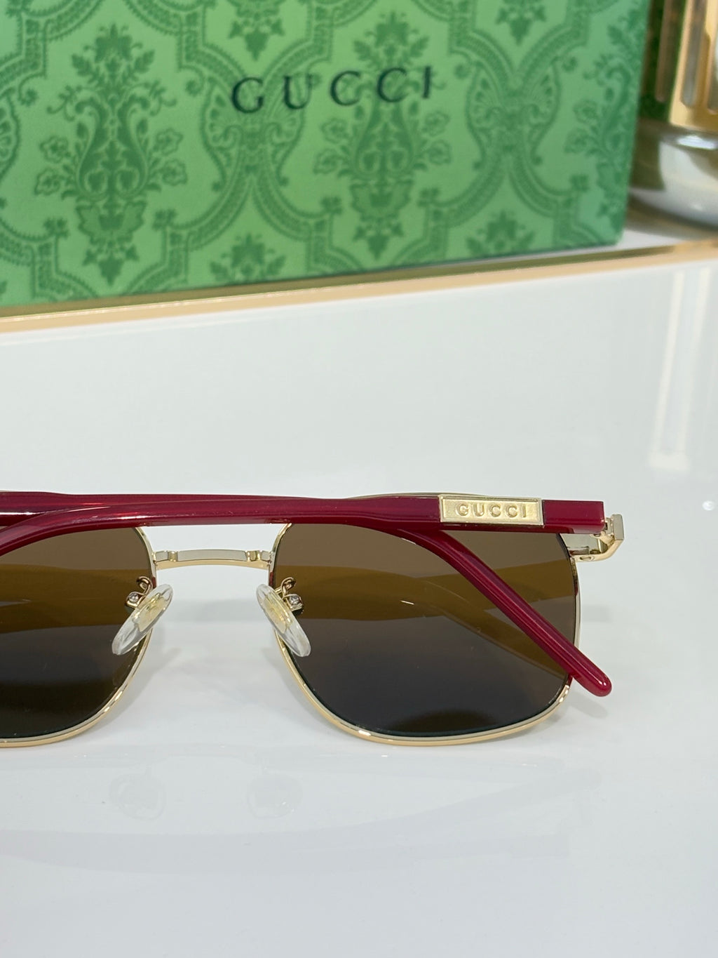 Gucci sunglasses with dark lenses and red temples