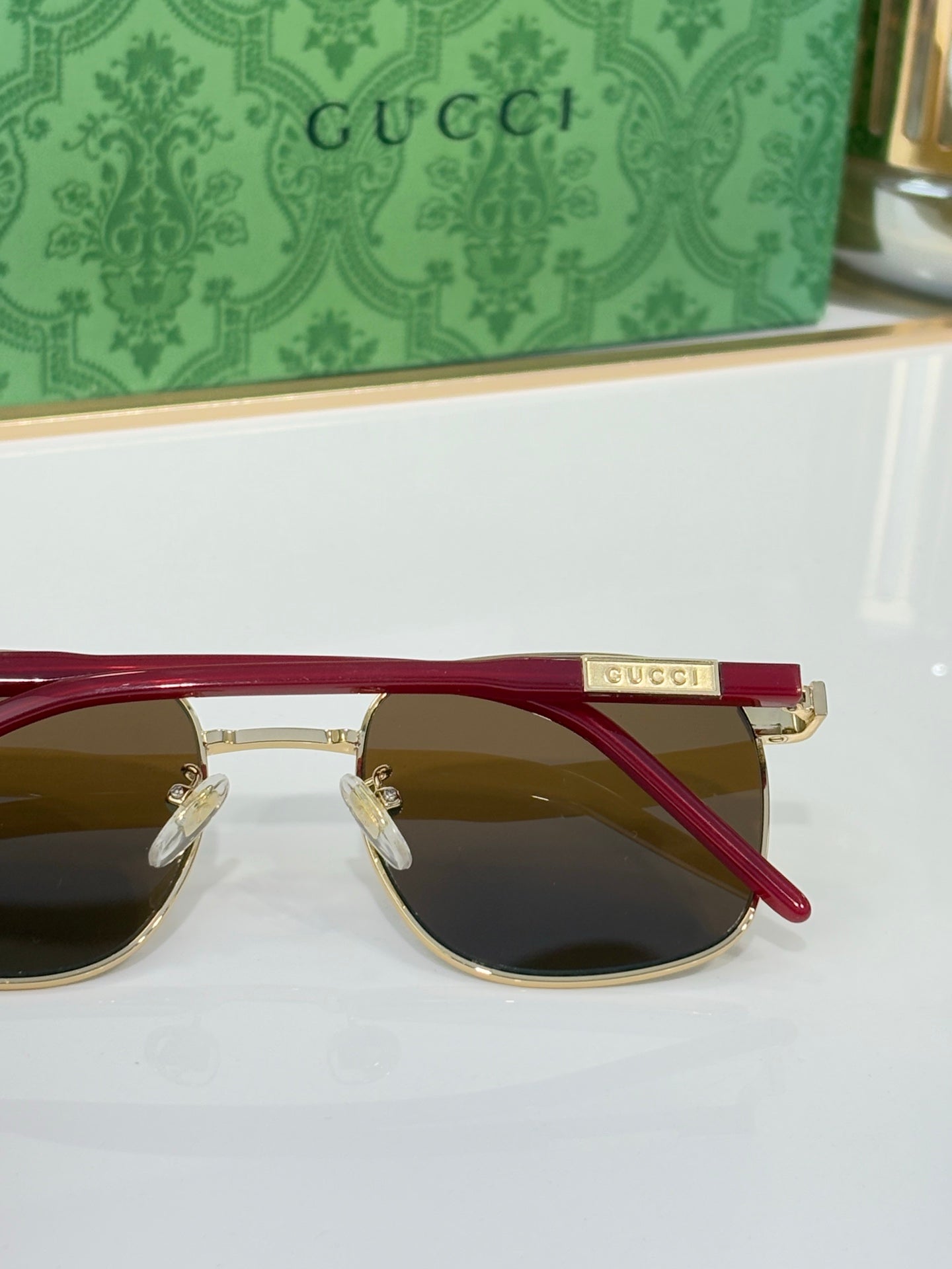 Gucci sunglasses with dark lenses and red temples