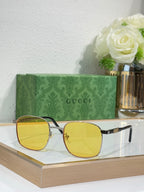Gucci sunglasses with gold frame and yellow tinted lenses