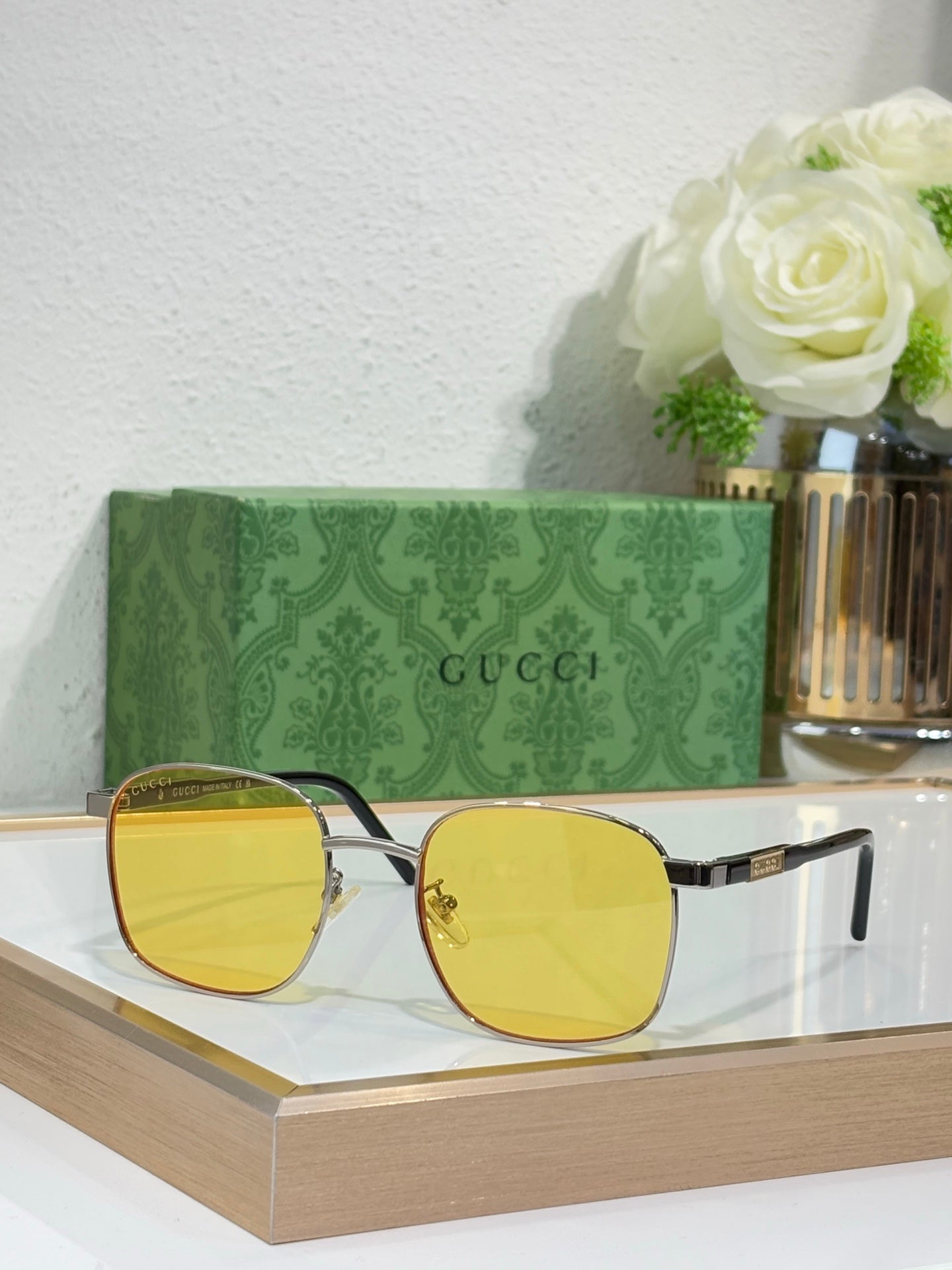 Gucci sunglasses with gold frame and yellow tinted lenses