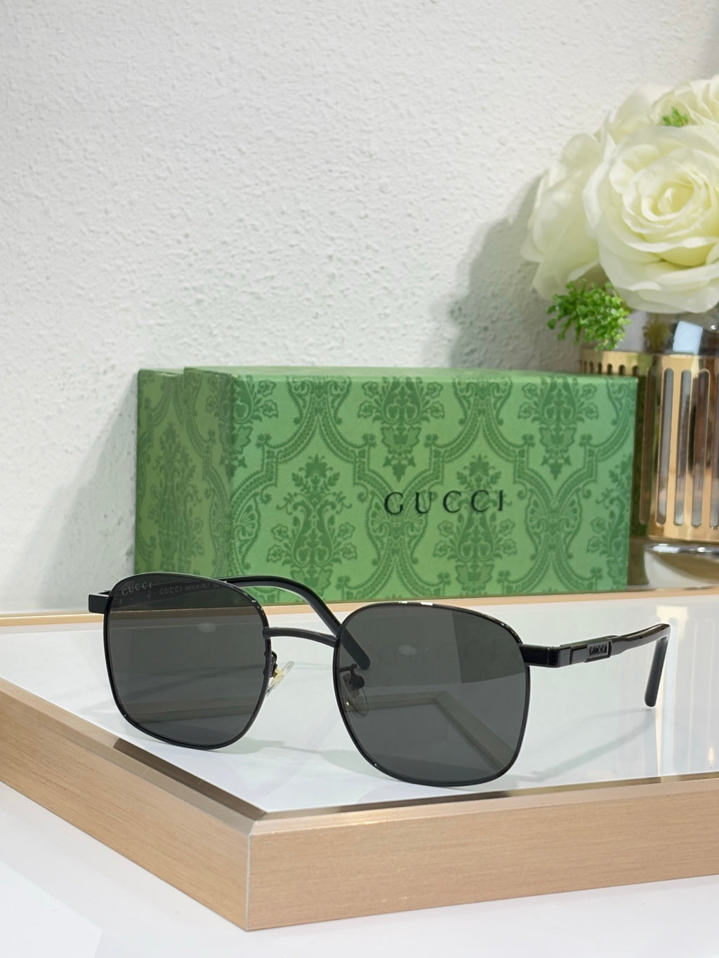 Gucci sunglasses with dark lenses and black frame