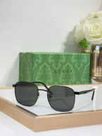 Gucci sunglasses with dark lenses and black frame