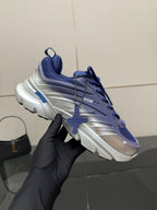 Blue and silver sneaker held up, lace-up design and logo detail on side