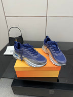 Pair of blue lace-up sneakers with silver outsole and side stripe accents