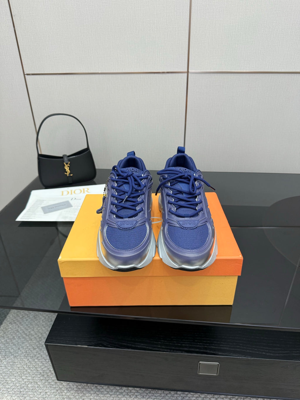 Blue and silver low-top sneakers with lace-up front and chunky sole