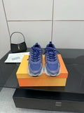 Blue and silver low-top sneakers with lace-up front and chunky sole