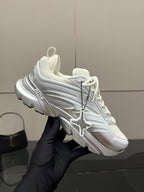 Hand-held white and silver low-top sneaker with Dior logo and cross strap detail