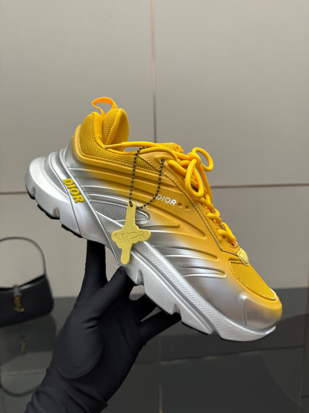 Women’s Dior lace-up sneaker, yellow with silver sole, held with charm detail