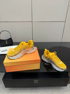 Women’s Dior lace-up sneakers set, yellow pairs with silver soles on boxes