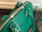 Louis Vuitton green handbag close-up of zipper track and silver-tone D-ring