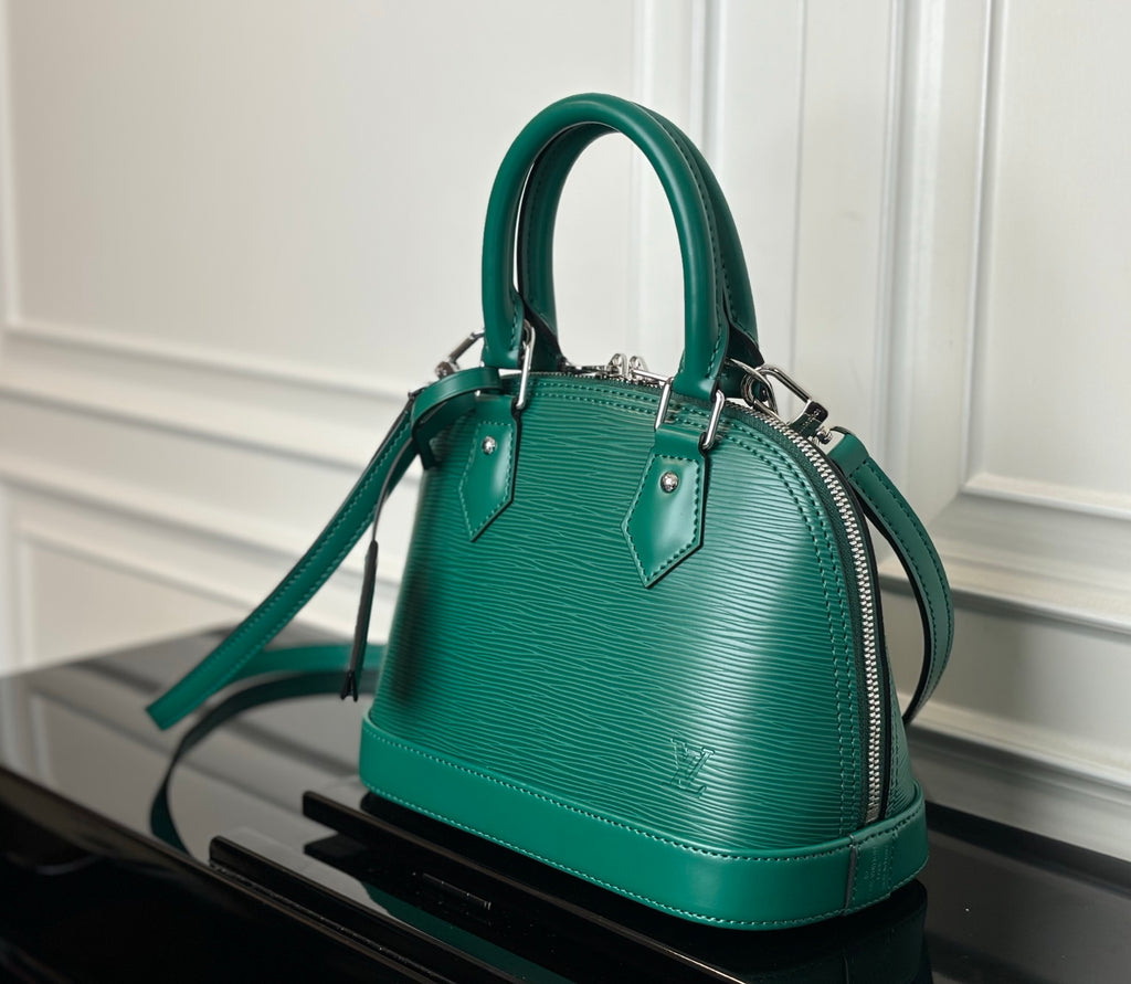 Louis Vuitton green handbag front view with structured top handles and shoulder strap