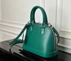 Louis Vuitton green handbag front view with structured top handles and shoulder strap