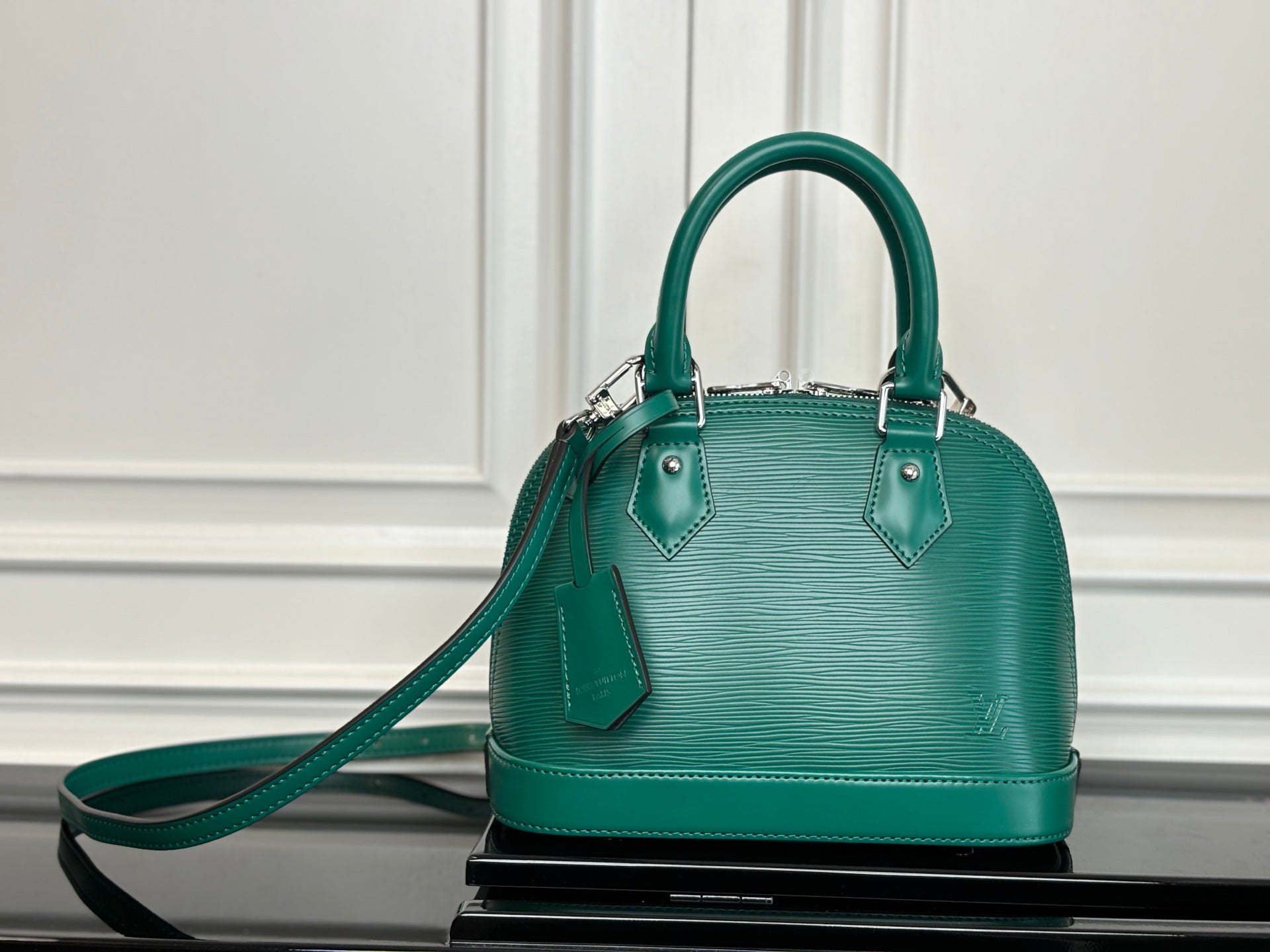 Louis Vuitton green leather-look handbag with top handles and crossbody strap