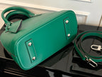 Louis Vuitton green handbag with rolled top, silver-tone hardware, and top handle