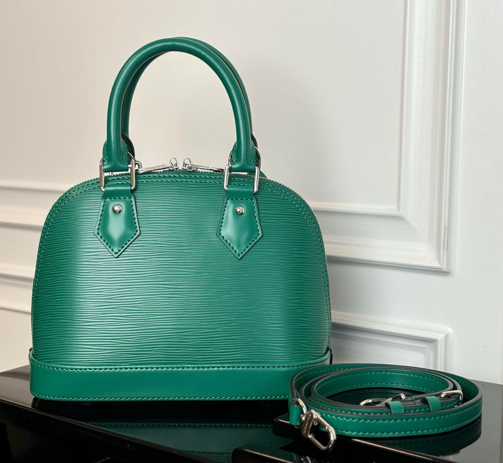 Louis Vuitton green handbag with two top handles and matching crossbody strap