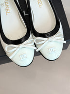 White ballet flats with black patent trim and bow, Chanel logo