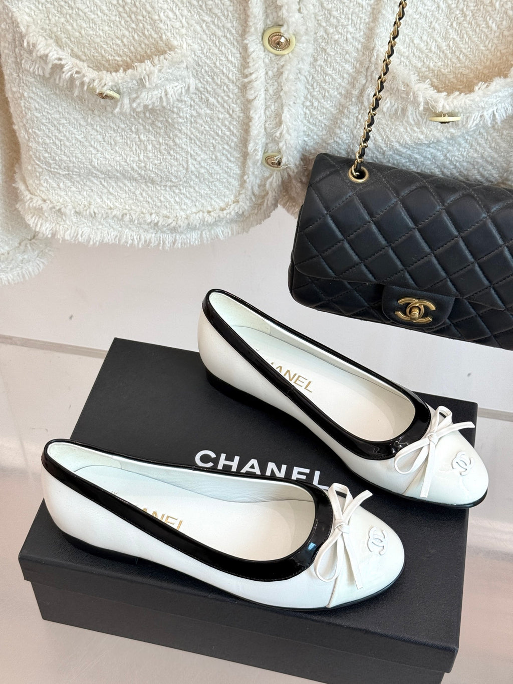 Pair of white ballet flats with black edging and ribbon bow, Chanel