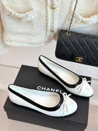 Pair of white ballet flats with black edging and ribbon bow, Chanel
