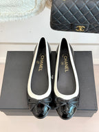 Black ballet flats with white piping and bow, Chanel logo on insole